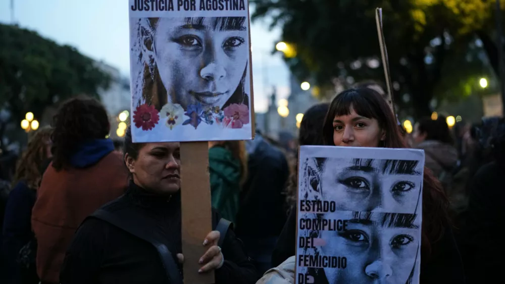 Demonstrators hold photos of 14-year-old Agostina Vega, who was murdered, during a march marking the anniversary of the "Ni Una Menos" (Not One Fewer) women's movement in Buenos Aires, Argentina, Wednesday, June 3, 2026. (AP Photo/Natacha Pisarenko)