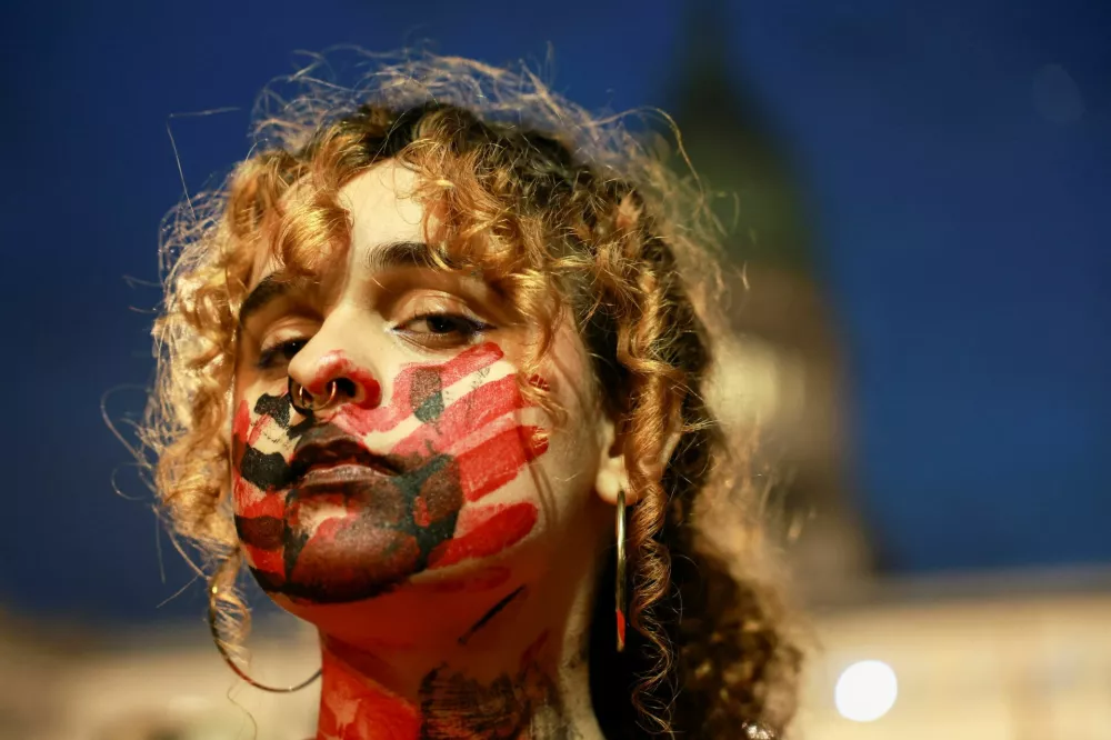A demonstrator looks on as members of the women's movement "Ni Una Menos" (Not one (woman) less) protest amid public outrage following the femicide of 14-year-old Agostina Vega in Cordoba province, outside the National Congress, in Buenos Aires, Argentina, June 3, 2026. REUTERS/Cristina Sille   TPX IMAGES OF THE DAY