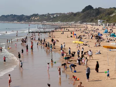 People enjoy the warm weather on Bournemouth beach, in Dorset, England, Wednesday April 8, 2026. (Andrew Matthews/PA via AP)