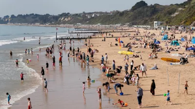 People enjoy the warm weather on Bournemouth beach, in Dorset, England, Wednesday April 8, 2026. (Andrew Matthews/PA via AP)
