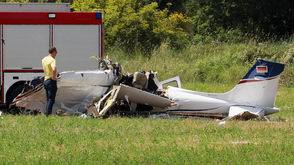 A person inspects a small plane which crashed near Medulin, Croatia, Thursday, June 4, 2026. (AP Photo/Goran Sebelic)