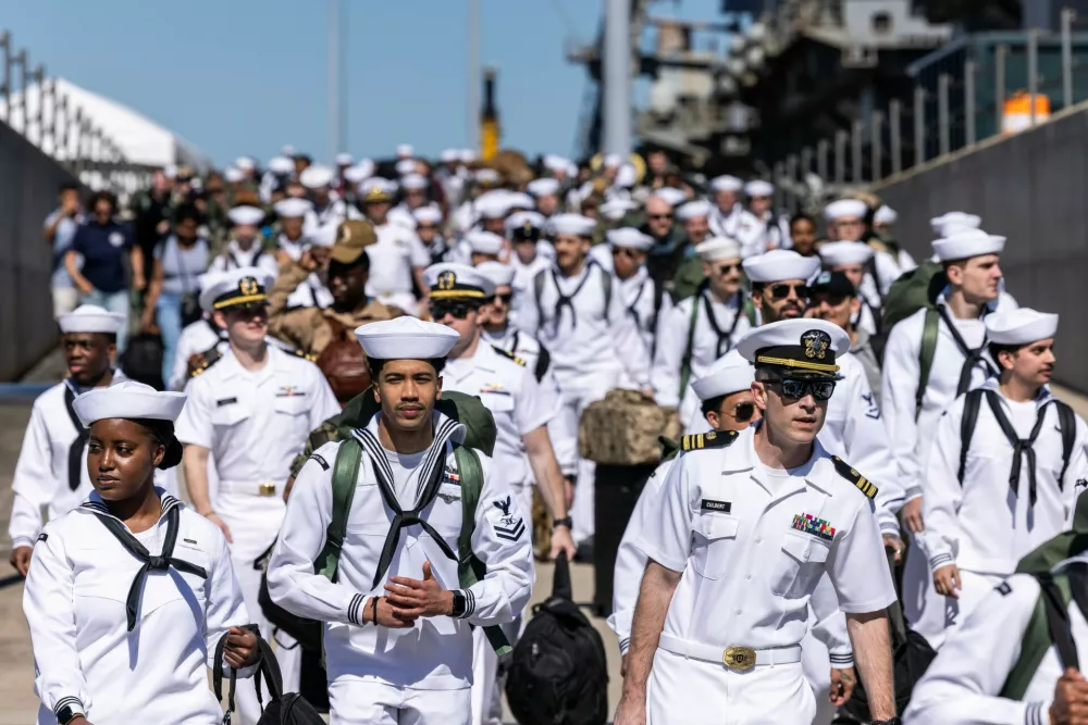 Sailors walk off of Pier 11 to find their loved ones after disembarking from the USS Gerald R. Ford at Naval Station Norfolk in Norfolk, Va. on Saturday, May 16, 2026, following an 11 month deployment. (Kendall Warner/The Virginian-Pilot via AP)