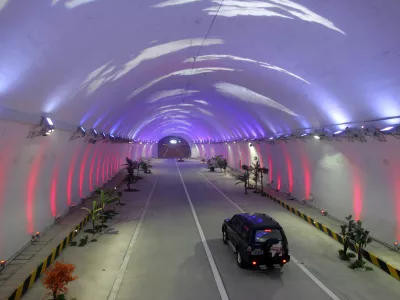 A vehicle moves thorugh the Zhongnanshan tunnel which passes through the Qinling Mountains in northwest China's Shaanxi province January 17, 2007. The 18-kilometer tunnel, which will open on January 20, is equipped with lights that show different colors and patterns to make drivers feel more alert and is expected to shorten the journey from Zuoshui county to Xi'an in Shaanxi province to one hour from three, China Daily reported. Picture taken January 17, 2007. CHINA OUT REUTERS/China Daily (CHINA)