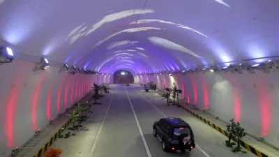 A vehicle moves thorugh the Zhongnanshan tunnel which passes through the Qinling Mountains in northwest China's Shaanxi province January 17, 2007. The 18-kilometer tunnel, which will open on January 20, is equipped with lights that show different colors and patterns to make drivers feel more alert and is expected to shorten the journey from Zuoshui county to Xi'an in Shaanxi province to one hour from three, China Daily reported. Picture taken January 17, 2007. CHINA OUT REUTERS/China Daily (CHINA)