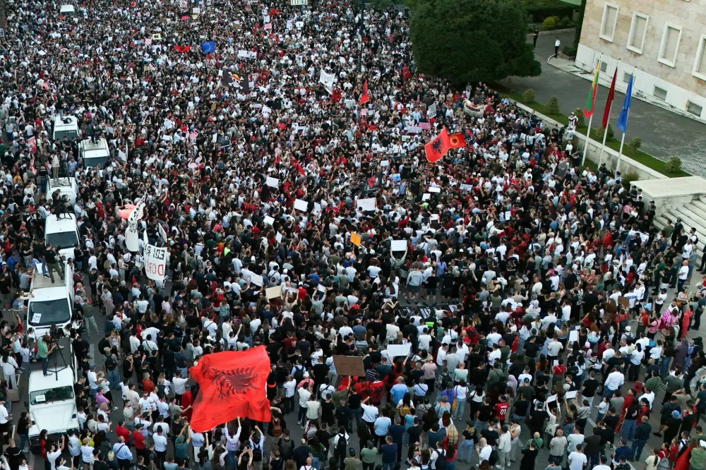 A drone view shows demonstrators holding banners during a protest against a luxury resort development planned by a company linked with Donald Trump's son-in-law, Jared Kushner, on an environmentally sensitive part of the Adriatic coast, in Tirana, Albania, June 4, 2026. REUTERS/Florion Goga