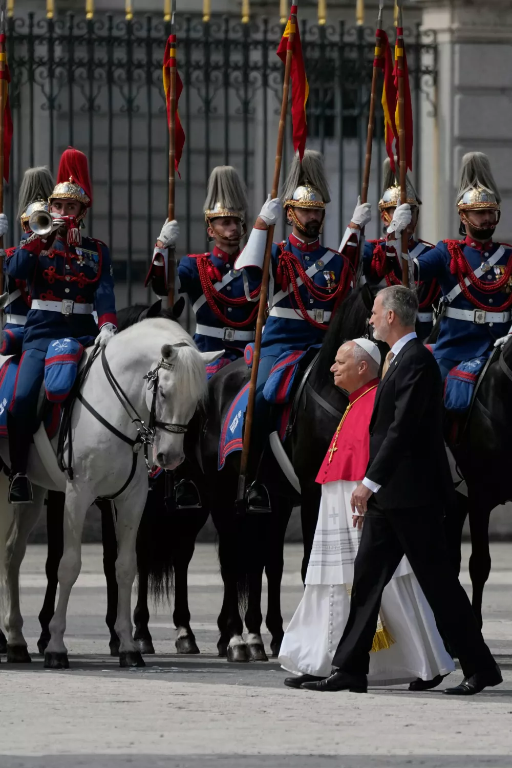 Pope Leo XIV and King of Spain Felipe VI review the honour guard at the at the Royal Palace in Madrid, Saturday, June 6, 2026, on the occasion of his Apostolic journey to Spain. (AP Photo/Alessandra Tarantino)