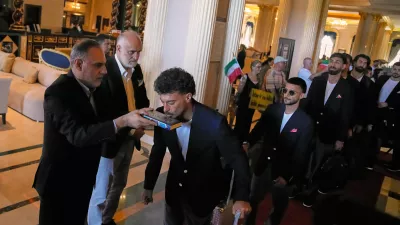 Iran's players kiss the Muslim's holiest book Quran as they leave to Antalya airport, southern Turkey, Saturday, June 6, 2026, before departing to Tijuana, Mexico, for the World Cup soccer tournament. (AP Photo/Khalil Hamra)