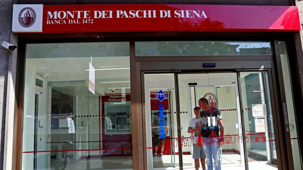FILE PHOTO: People are seen inside a Monte dei Paschi di Siena bank in Rome, Italy August 16, 2018. REUTERS/Max Rossi/File Photo