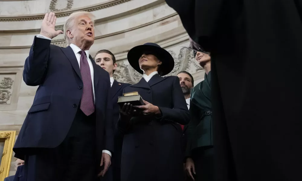 Donald Trump is sworn in as the 47th president of the United States by Chief Justice John Roberts as Melania Trump holds the Bible during the 60th Presidential Inauguration in the Rotunda of the U.S. Capitol in Washington, Monday, Jan. 20, 2025. (AP Photo/Morry Gash, Pool)