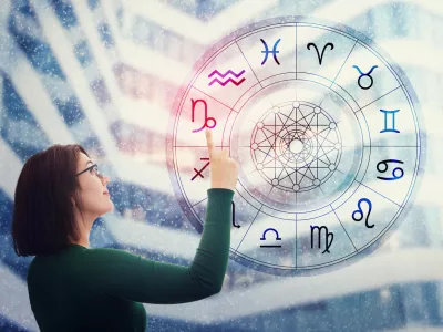 Woman choosing a zodiac sign from the astrological wheel to find the future predictions. Having trust in horoscope, consulting stars and believe in the power of universe. Astrology esoteric concept.