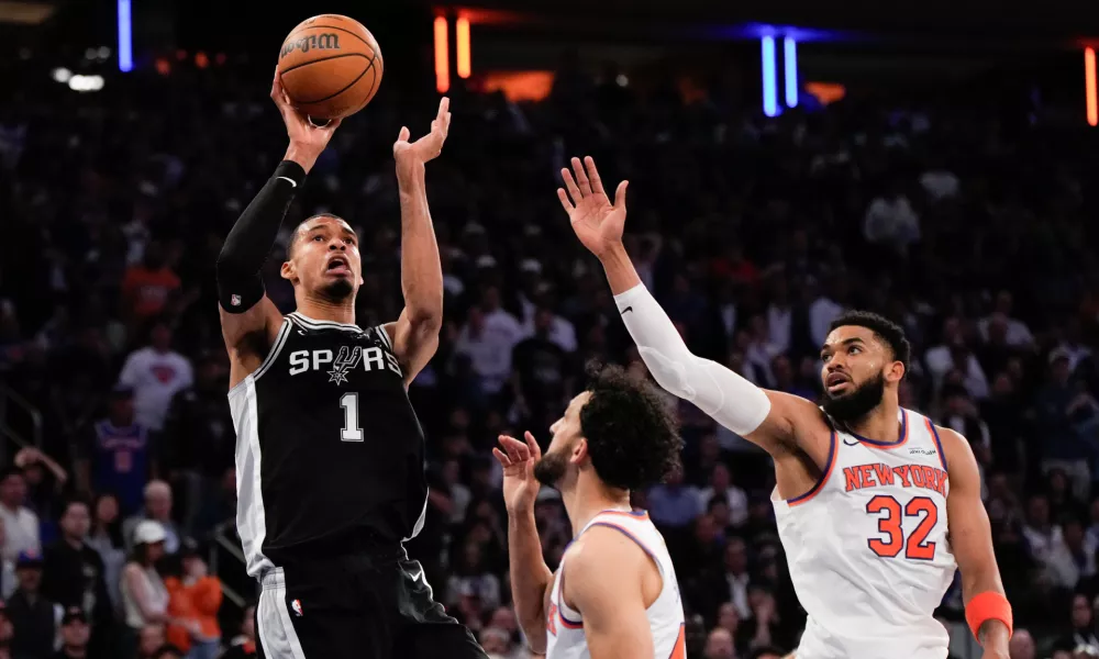 San Antonio Spurs forward Victor Wembanyama (1) shoots over New York Knicks center Karl-Anthony Towns (32) during second half of Game 3 of the NBA Finals basketball series, Monday, June 8, 2026, in New York. (AP Photo/Ross D. Franklin)