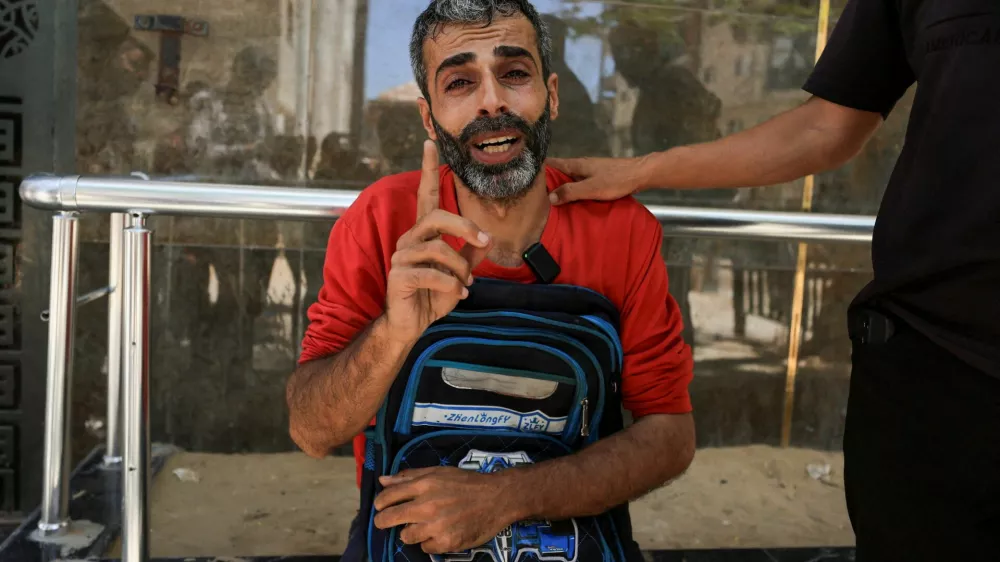 Palestinian father Youssef Salman mourns as he carries the school bag of his eight-year-old son Jad, who was killed in an Israeli strike on the Jabalia refugee camp, according to medics, at Al-Shifa hospital in Gaza City, June 8, 2026. REUTERS/Dawoud Abu Alkas   TPX IMAGES OF THE DAY