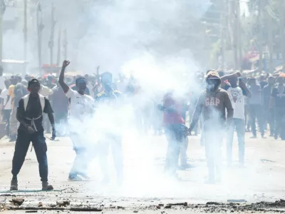 Demonstrators react after riot police lobbed tear gas cannisters to disperse during a protest against a U.S.-backed Ebola quarantine plan to establish a 50-bed facility at a Kenyan air force base intended to host Americans exposed to Ebola, in Nanyuki town, Laikipia County, Kenya, June 9, 2026. REUTERS/Monicah Mwangi