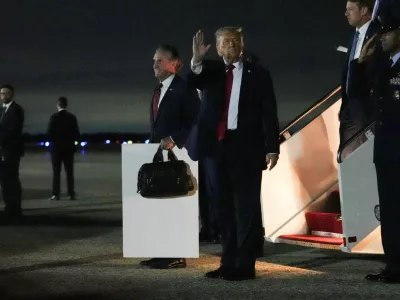 U.S. President Donald Trump waves as he disembarks from Air Force One, after attending Game 3 of the NBA Finals, at Joint Base Andrews, Maryland, U.S., June 9, 2026. REUTERS/Nathan Howard