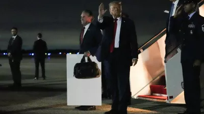 U.S. President Donald Trump waves as he disembarks from Air Force One, after attending Game 3 of the NBA Finals, at Joint Base Andrews, Maryland, U.S., June 9, 2026. REUTERS/Nathan Howard