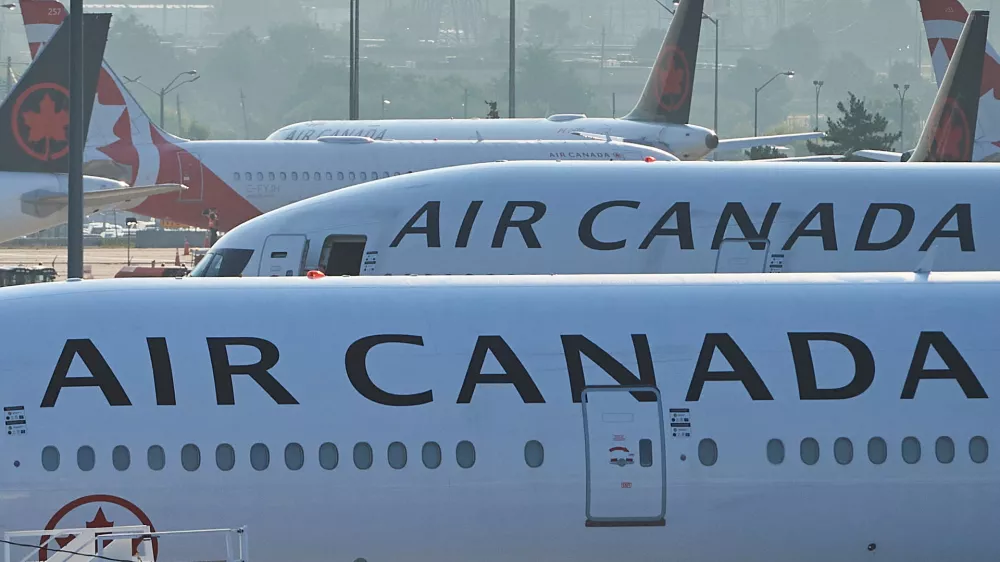 FILE - Air Canada planes sit on the runway at Pearson International Airport in Toronto on Aug. 16, 2025. (Sammy Kogan/The Canadian Press via AP, File)