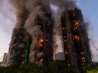 FILE - Smoke rises after a fire broke out at Wang Fuk Court, a residential estate in the Tai Po district of Hong Kong's New Territories, Nov. 26 2025. (AP Photo/Chan Long Hei, File)
