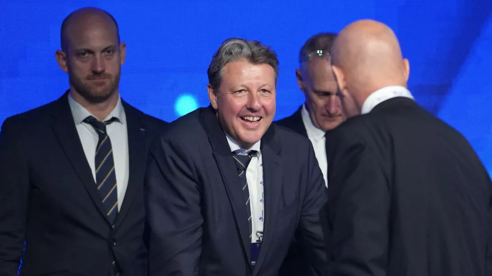 Newly chosen president of the International Ski and Snowboard Federation (FIS) Alexander Ospelt, center, speaks with former FIS president Johan Eliasch, front right, during the 57th International FIS Congress 2026, in Belgrade, Serbia, Thursday, June 11, 2026. (AP Photo/Darko Vojinovic)