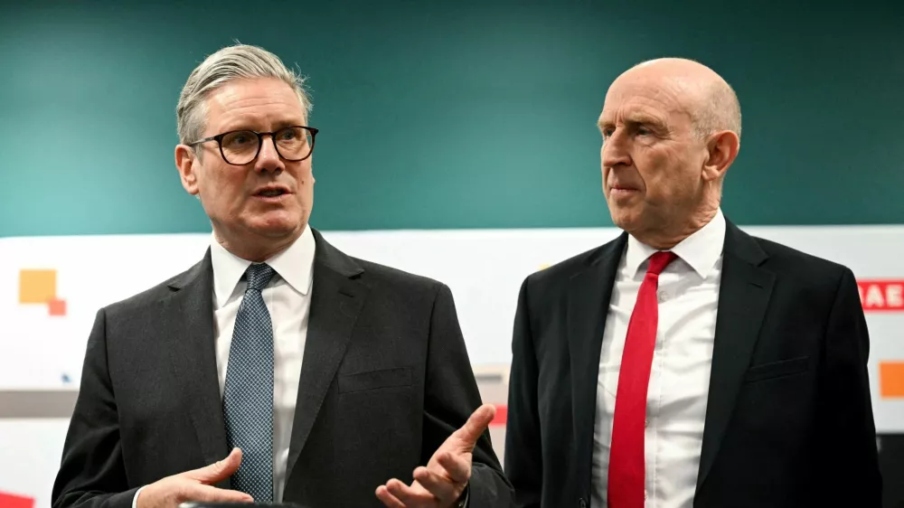 FILE PHOTO: Britain's Prime Minister Keir Starmer and Britain's Defence Secretary John Healey meet with BAE system apprentices during a joint visit in Barrow-in-Furness, Britain, on March 20, 2025.   OLI SCARFF/Pool via REUTERS/File Photo