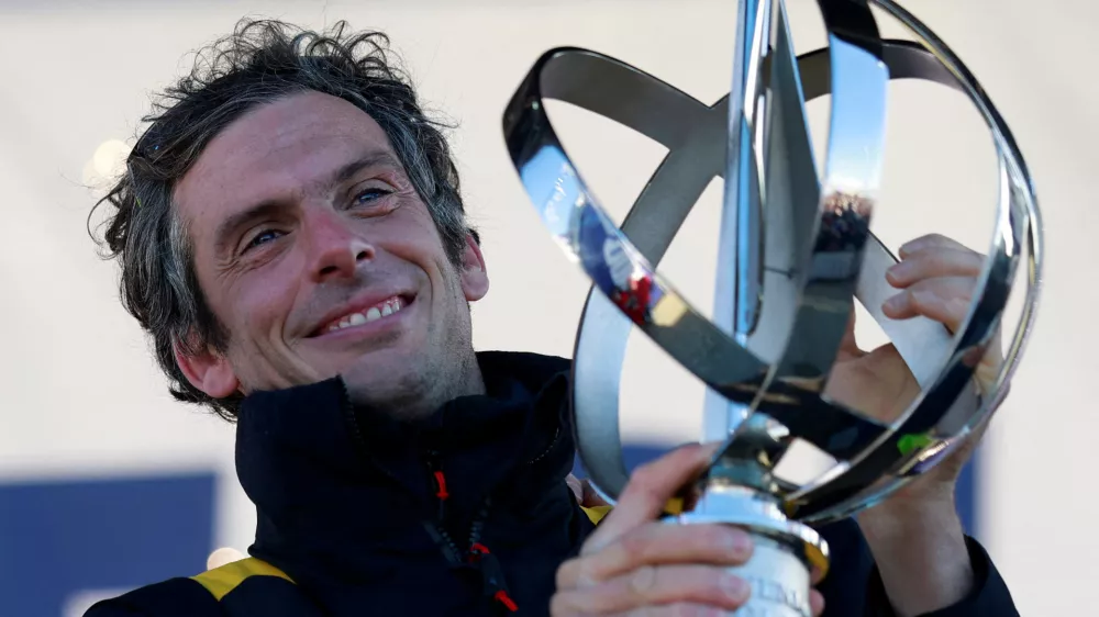 FILE PHOTO: Sailing - Arrival of the Vendee Globe winner - Les Sables-d'Olonne, France - January 14, 2025 Macif Sante Prevoyance's Charlie Dalin holds the trophy onstage as he arrives in port after winning the Vendee Globe REUTERS/Stephane Mahe/File Photo