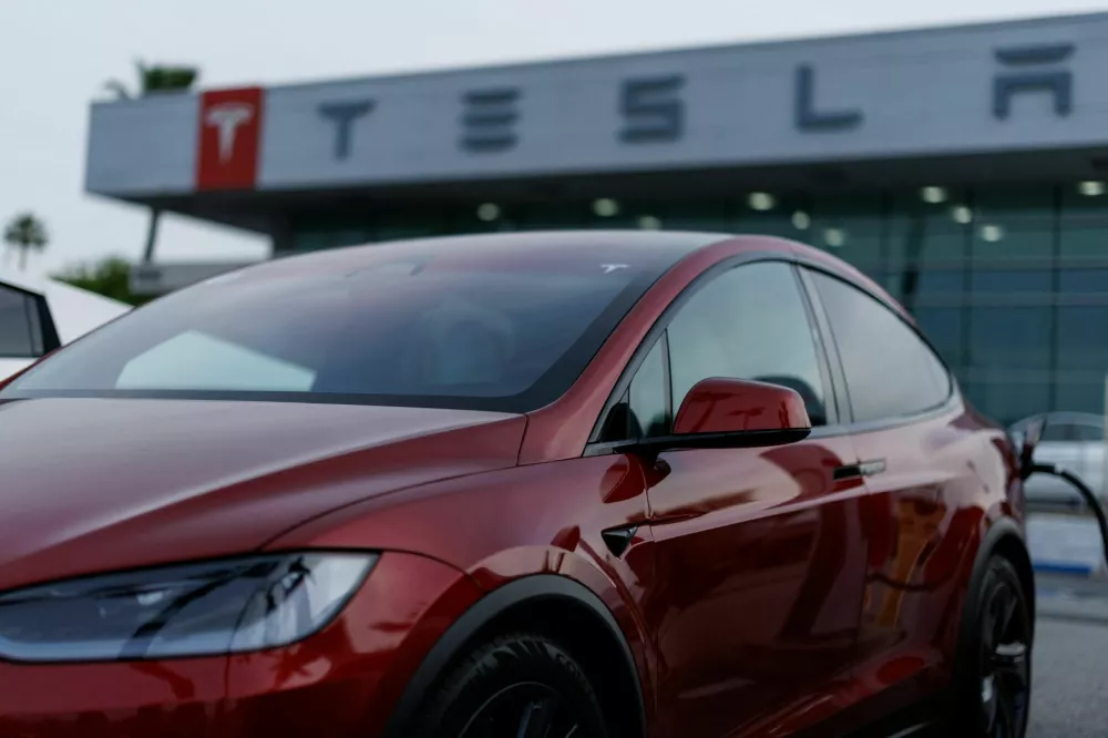 A Tesla model Y is shown charging at a Tesla dealership in Buena Park, California, U.S., January 28, 2026. REUTERS/Mike Blake