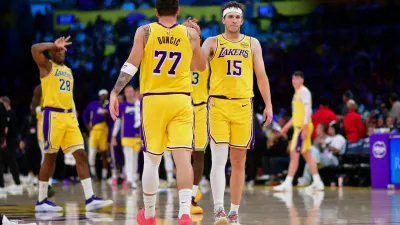 Mar 12, 2026; Los Angeles, California, USA; Los Angeles Lakers guard Luka Doncic (77) and guard Austin Reaves (15) react during the second half at Crypto.com Arena. Mandatory Credit: Gary A. Vasquez-Imagn Images