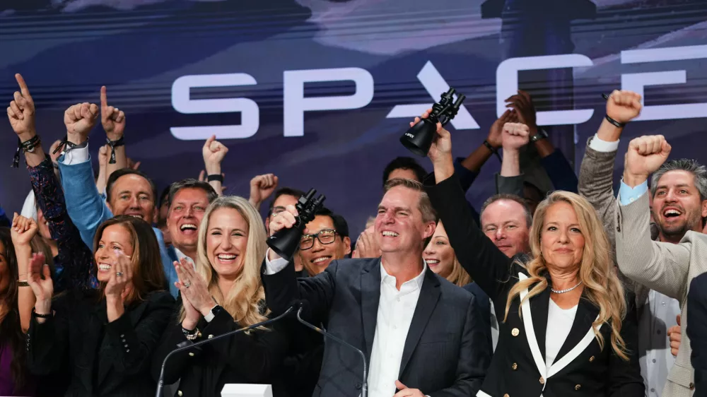 Gwynne Shotwell, President and COO of SpaceX, right, celebrates with colleagues during a bell ringing ceremony for the IPO of SpaceX at the Nasdaq MarketSite in New York, Friday, June 12, 2026, in New York. (AP Photo/Frank Franklin II)