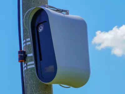 Closeup of a modern speed camera (traffic speed monitoring camera) against a clear blue sky