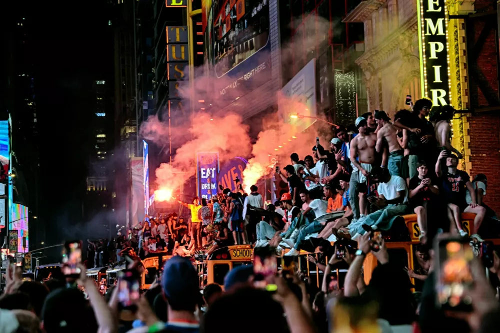 New York Knicks fans celebrate their victory after Game 5 of the NBA Finals basketball series against the San Antonio Spurs, Saturday, June 13, 2026, in New York. (AP Photo/Heather Khalifa)