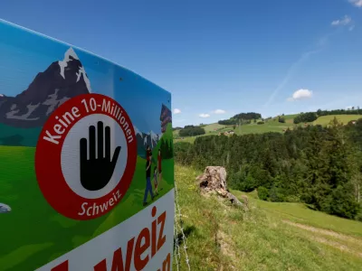 A sign sits in a field, on the day of the vote on a plan backed by the right-wing Swiss People's Party (SVP) to limit population growth to 10 million inhabitants, near Hundwil, Switzerland, June 14, 2026. REUTERS/Michaela Stache
