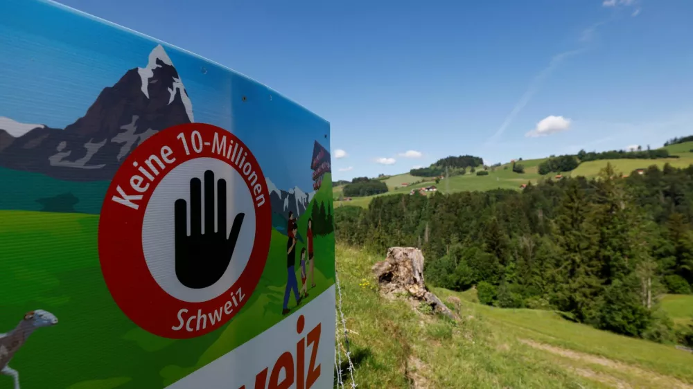 A sign sits in a field, on the day of the vote on a plan backed by the right-wing Swiss People's Party (SVP) to limit population growth to 10 million inhabitants, near Hundwil, Switzerland, June 14, 2026. REUTERS/Michaela Stache