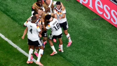 Germany's Nathaniel Brown (18) is congratulated by teammates after scoring during the World Cup Group E soccer match between Germany and Curacao in Houston, Sunday, June 14, 2026. (AP Photo/Michael Wyke)