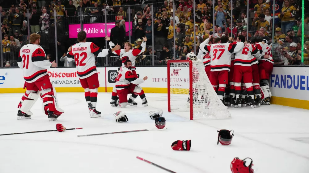 Jun 14, 2026; Las Vegas, Nevada, USA; Carolina Hurricanes players celebrate the win against the Vegas Golden Knights in game six of the 2026 Stanley Cup Final at T-Mobile Arena. Mandatory Credit: Stephen R. Sylvanie-Imagn Images