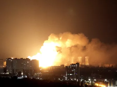 An explosion lights up the sky over the city during a Russian missile and drone strike, amid Russia's attack on Ukraine, in Kyiv, Ukraine June 15, 2026. REUTERS/Anna Voitenko