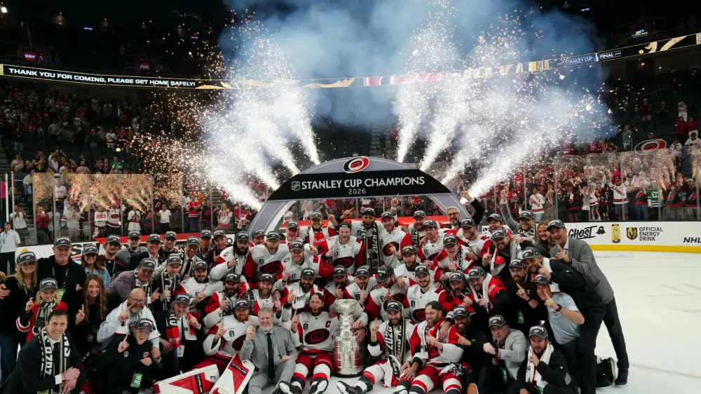 Jun 14, 2026; Las Vegas, Nevada, USA; The Carolina Hurricanes pose with the the Stanley Cup after defeating Vegas Golden Knights in game six of the 2026 Stanley Cup Final at T-Mobile Arena. Mandatory Credit: Stephen R. Sylvanie-Imagn Images   TPX IMAGES OF THE DAY