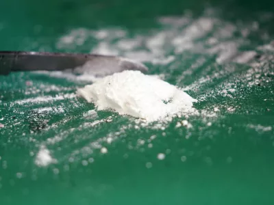 FILED - 24 February 2022, Hamburg: A press spokesman for Hamburg customs presents a small part of a seized cocaine find at a media event in the port. Photo: Marcus Brandt/dpa