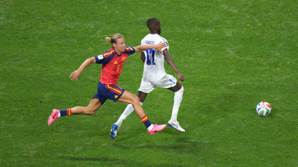 Spain's Marcos Llorente (5) grabs Cape Verde's Willy Semedo (17) during the World Cup Group H soccer match between Spain and Cape Verde in Atlanta, Monday, June 15, 2026. (AP Photo/Jacob Kupferman)