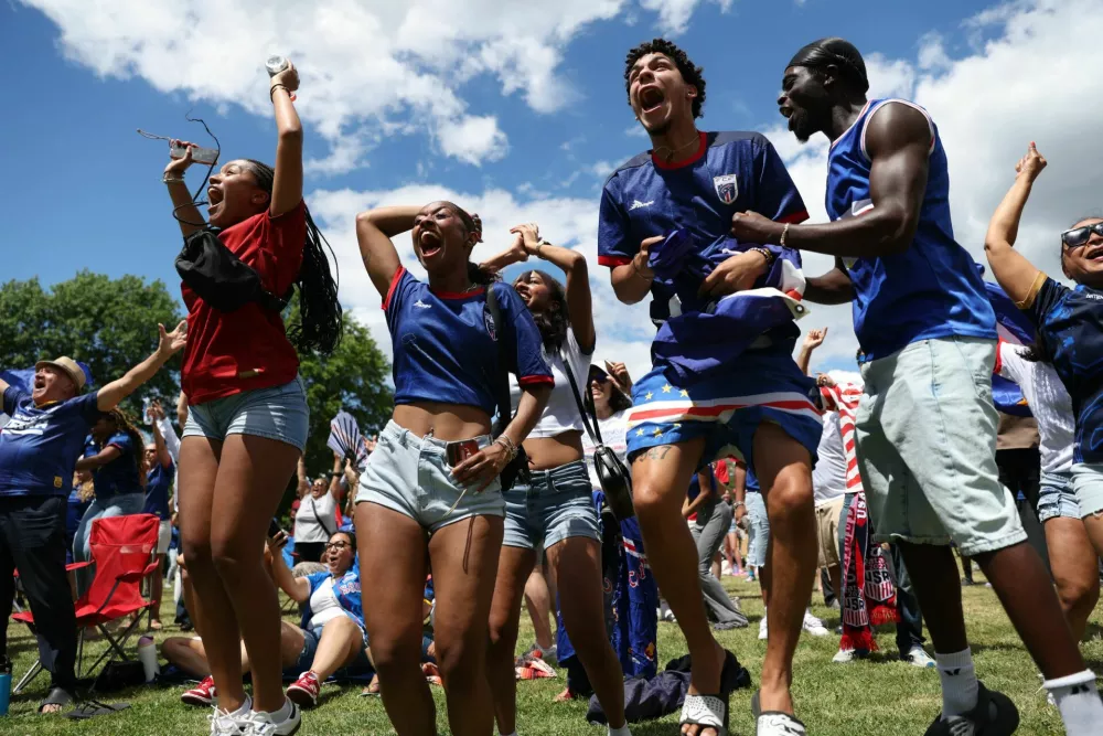 Soccer Football - FIFA World Cup 2026 - Group H - Spain v Cape Verde - Fans gather in Boston - Boston, Massachusetts, U.S. - June 15, 2026 Cape Verde fans Ginaldo Verdieu, Alex Monteiro and Bruna Barbosa react as they watch the match on a screen at Town Field Park in Dorchester REUTERS/Taylor Coester