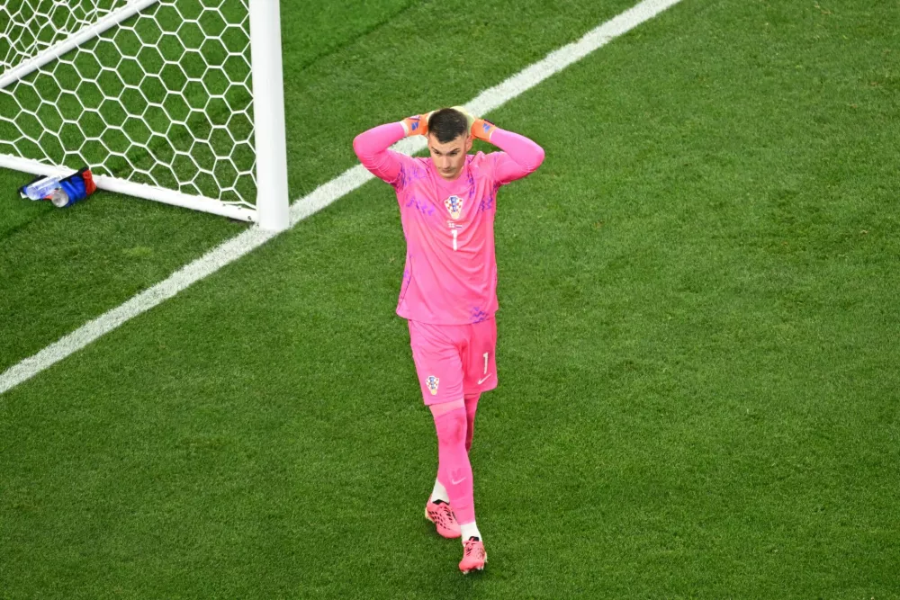 Croatia goalkeeper Dominik Livakovic (1) reacts during the World Cup Group L soccer match between England and Croatia in Arlington, Texas, near Dallas, Wednesday June 17, 2026. (AP Photo/Jessica Tobias)