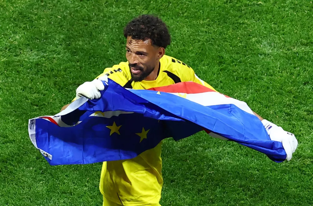 Soccer Football - FIFA World Cup 2026 - Group H - Spain v Cape Verde - Atlanta Stadium, Atlanta, Georgia, U.S. - June 15, 2026 Cape Verde's Vozinha celebrates with their national flag after the match REUTERS/Bernadett Szabo