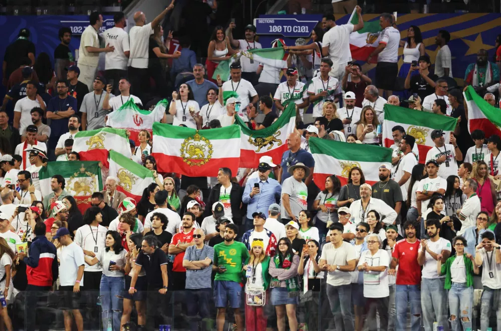 Soccer Football - FIFA World Cup 2026 - Group G - Iran v New Zealand - Los Angeles Stadium, Inglewood, California, U.S. - June 15, 2026 Fans hold pre-Iranian Revolution "Lion and Sun" flags in the stands after the match IMAGN IMAGES via Reuters/Kiyoshi Mio