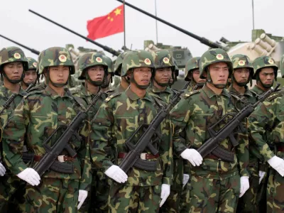 ** FILE ** Chinese troops line up in front of their tanks in Qingdao, in east China's Shangdong Province, during "Peace Mission 2005" Sino-Russian joint military exercise in this Aug. 22, 2005 file photo. China warned the United States and other governments on Thursday, Sept. 1, 2005 against using missile-defense systems to protect rival Taiwan or helping the island produce its own system. (AP Photo/Xinhua, Wang Jianmin, File)