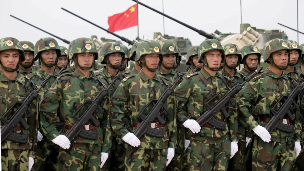 ** FILE ** Chinese troops line up in front of their tanks in Qingdao, in east China's Shangdong Province, during "Peace Mission 2005" Sino-Russian joint military exercise in this Aug. 22, 2005 file photo. China warned the United States and other governments on Thursday, Sept. 1, 2005 against using missile-defense systems to protect rival Taiwan or helping the island produce its own system. (AP Photo/Xinhua, Wang Jianmin, File)