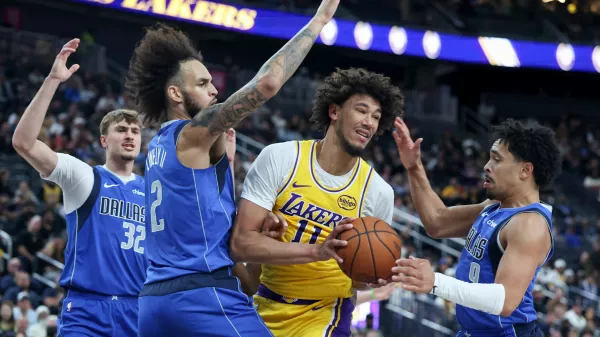 Los Angeles Lakers center Jaxson Hayes (11) secures a rebound against Dallas Mavericks center Dereck Lively II (2) and guard Ryan Nembhard (9) during the first half of a preseason NBA basketball game Wednesday, Oct. 15, 2025, in Las Vegas. (AP Photo/Ian Maule)
