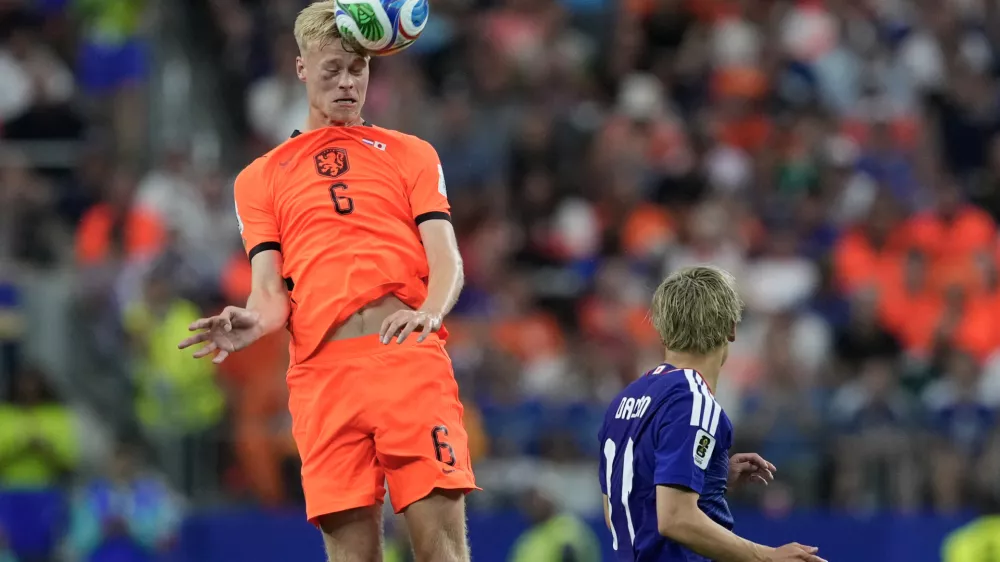 Netherlands' Jan Paul van Hecke heads the ball over Japan's Daizen Maeda during the World Cup Group F soccer match between the Netherlands and Japan in Arlington, Texas, near Dallas, Sunday, June 14, 2026. (AP Photo/Tony Guttierez)