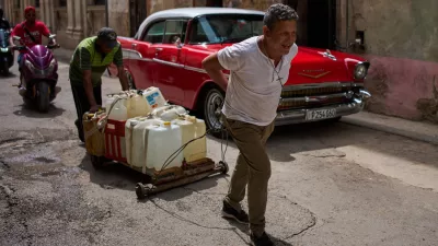 People transport containers of water in Havana, Wednesday, June 3, 2026. (AP Photo/Ramon Espinosa)