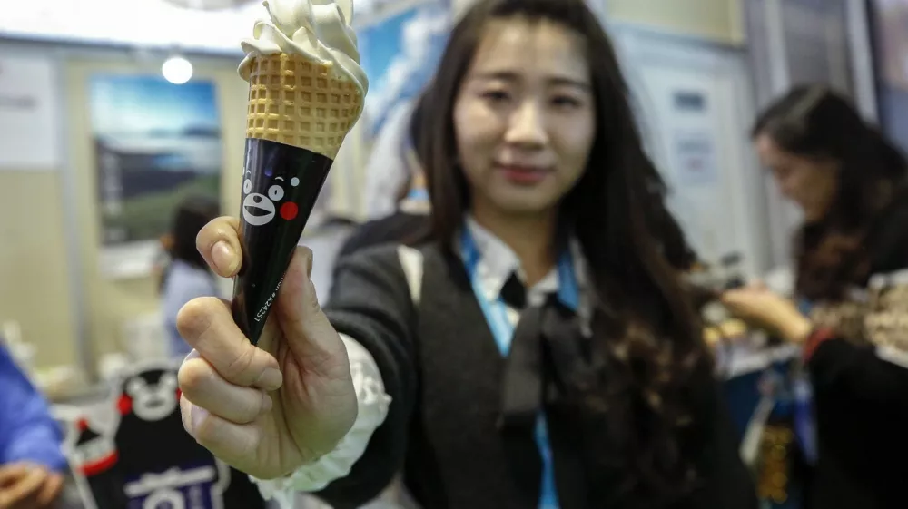 SHANGHAI, Nov. 10, 2019 A visitor shows a soy source-flavored ice cream from Japan at the Food and Agricultural Products exhibition area during the second China International Import Expo (CIIE) in Shanghai, east China, Nov. 8, 2019. The second CIIE was held from Nov. 5 to Nov. 10 at the National Exhibition and Convention Center in Shanghai.,Image: 482079668, License: Rights-managed, Restrictions:, Model Release: no 