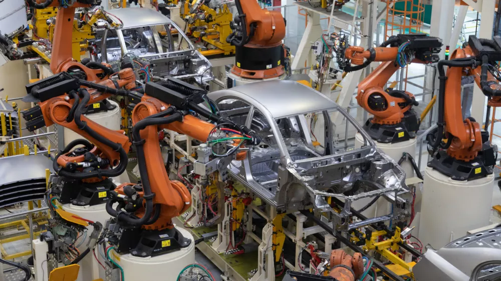 Modern technology of Assembly of cars. The plant of the automotive industry. Shop for the production and Assembly of machines top view. The process of welding parts of the car