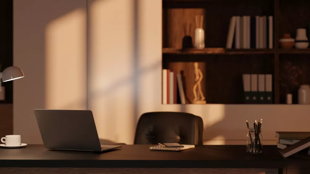 Modern private office room interior design with laptop, table lamp, stationery and office supplies on table, office chair, and built-in shelves with decor in the background. 3d render, 3d illustration