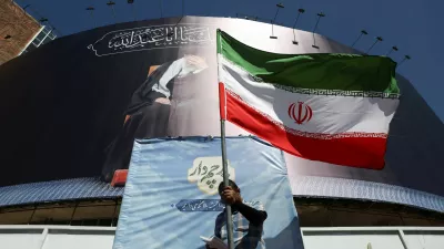 A man holds an Iranian flag on a street, after U.S. and Iranian officials said they had reached a deal to end their war and reopen the Strait of Hormuz, in Tehran, Iran, June 15, 2026. Majid Asgaripour/WANA (West Asia News Agency) via REUTERS  ATTENTION EDITORS - THIS PICTURE WAS PROVIDED BY A THIRD PARTY. ISRAEL OUT. NO COMMERCIAL OR EDITORIAL SALES IN ISRAEL. NO ACCESS FOR ISRAELI MEDIA. NO USE BBC PERSIAN. NO USE VOA PERSIAN. NO USE MANOTO. NO USE IRAN INTERNATIONAL. NO USE RADIO FARDA. DIGITAL: NO USE BBC PERSIAN. NO USE VOA PERSIAN. NO USE MANOTO. NO USE IRAN INTERNATIONAL. NO USE RADIO FARDA.